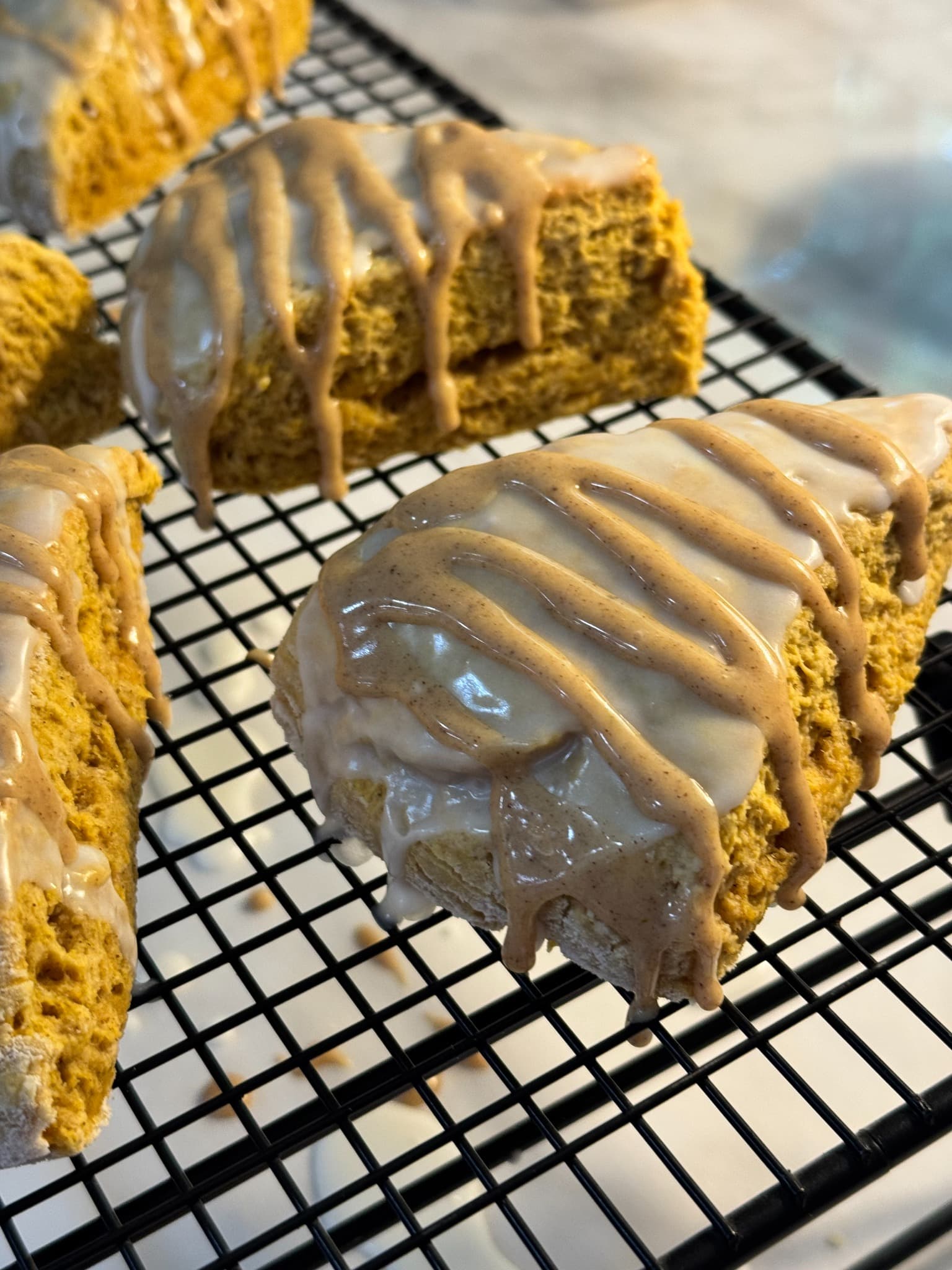Close-up of a glazed pumpkin scone